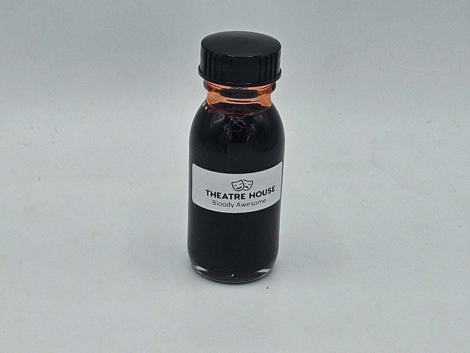 Stage Blood — poured pool of deep red theatrical blood showing color and texture