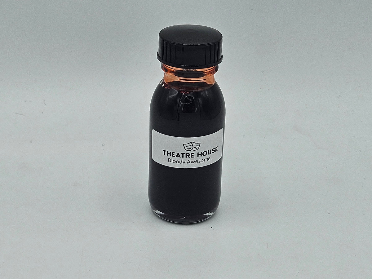 Stage Blood 2oz glass bottle — deep red theatrical blood, close-up
